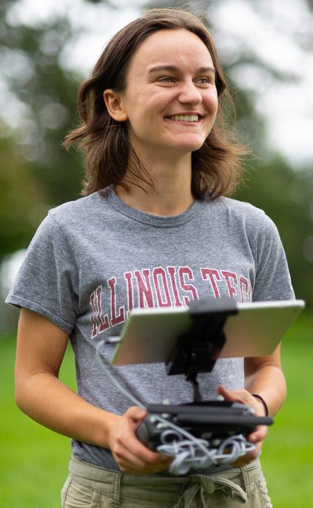 Illinois Tech student Sydney Kaplan operating a drone as part of her research at the Morton Arboretum.