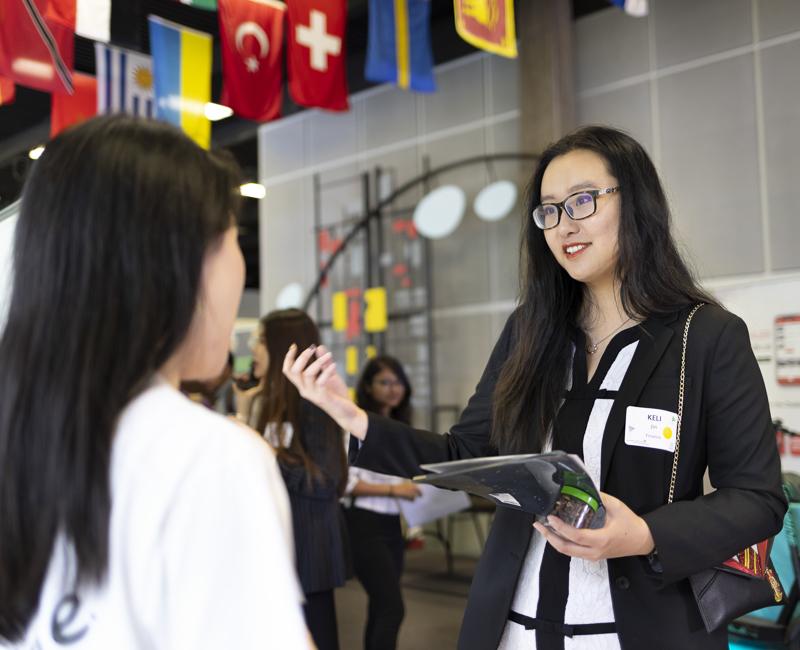 A student speaks with a potential employer at a career fair. 