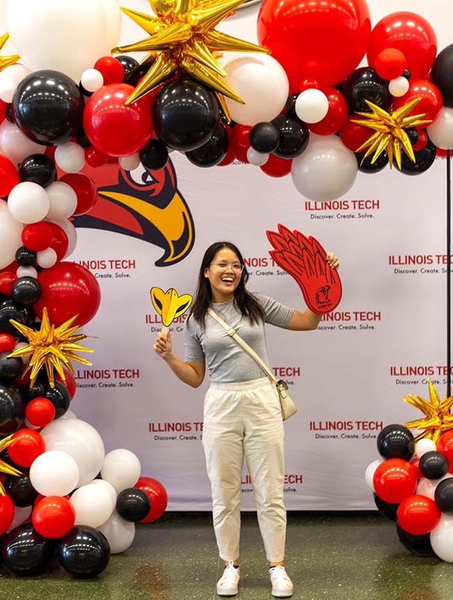 A new student poses for a photo during Convocation