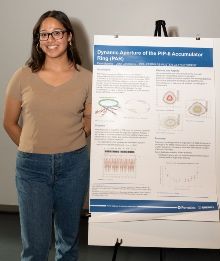 Applied mathematics students with a poster displaying her research