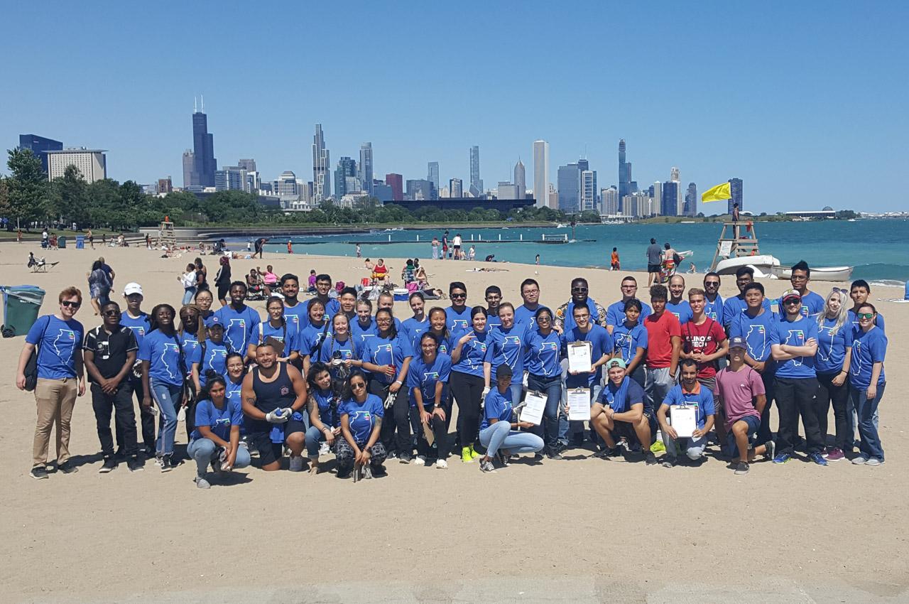 Group photo of students on beach with Chicago skyline in background