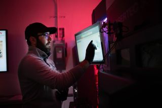 An Illinois Tech student works on a DMG Mori advanced manufacturing machine. 
