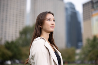 a woman in an MBA program stands in front of buildings in Chicago