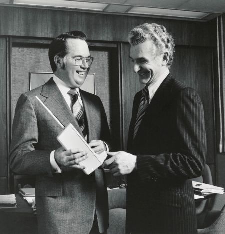 Motorola executives and alumni John F. Mitchell (EE ’50) and Martin Cooper (EE ’50, M.S. ’54) discussing a prototype Motorola DynaTAC cellular phone