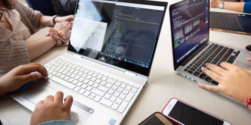 Illinois Tech students work on laptops