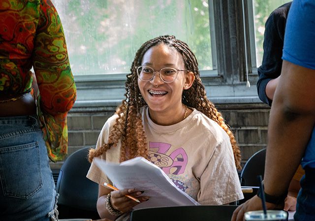 A student smiling during a 2023 summer program on psychology