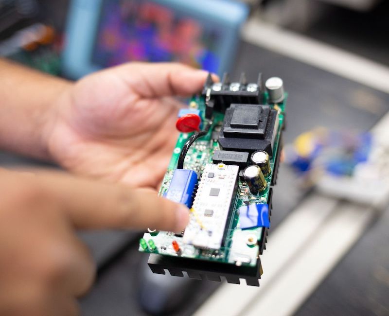 Electrical engineering student holds circuit board